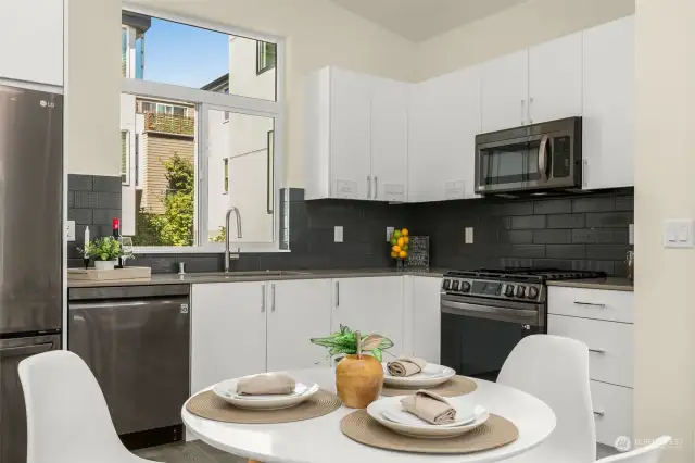 Your generously sized kitchen comes complete with black LG stainless steel appliances, ample quartz counter space, and custom cabinetry.