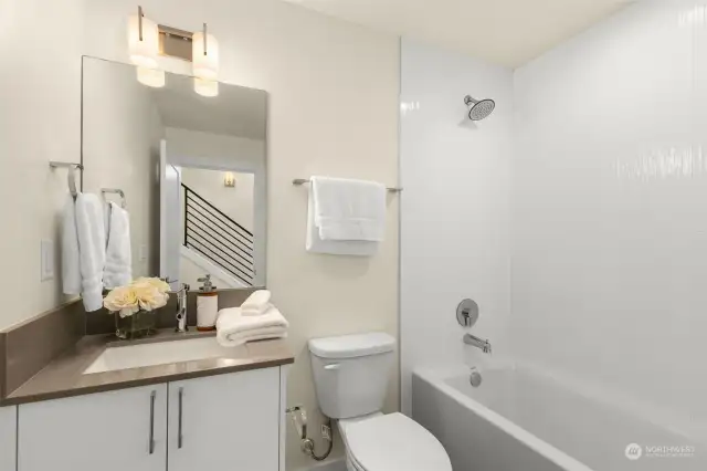 Spa-like bathrooms create a sense of serenity with floor to ceiling white tiling, custom made vanity & premium fixtures!