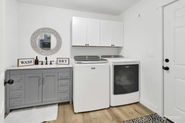 The laundry room offers new cabinetry, including a sink.  This room is the pass through between the home and garage.