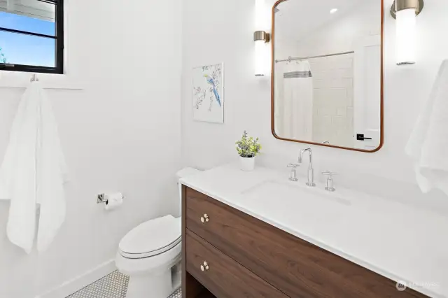 Conveniently located between the 2nd and 3rd bedrooms of the main house, the full bath features a deep bathtub, vaulted ceilings and heated floors.