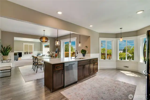 The eat-in island offers an ideal spot for guests to observe activities in the kitchen. Place a table in the breakfast nook and enjoy a of cup of tea while taking in the views.