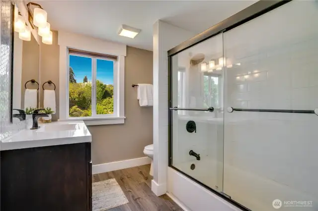 Finally, the upstairs bathroom! Plenty of storage and counterspace here! Full tile surround and backsplash complete this bathroom. Also, there is a laundry hook-up in the hallway between the bedrooms to make laundry life a bit easier.