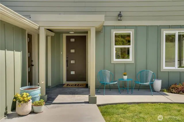 The front door enhances the modern aesthetic. The door to the garage provides convenient access to the front entrance, while an interior connection from garage to the lower level offers additional entry to the home.