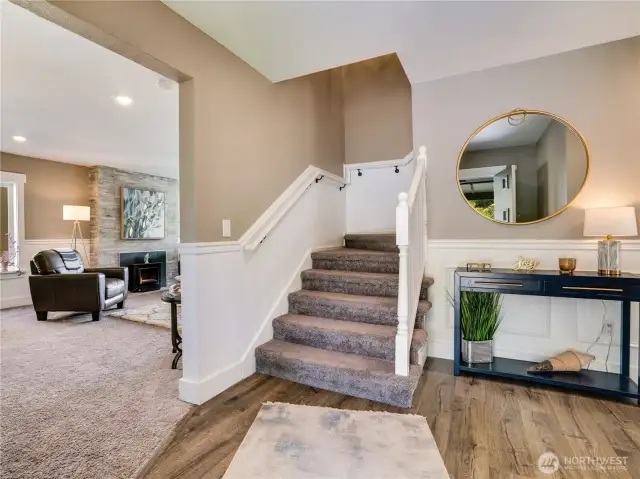The welcoming entry highlights the luxury vinyl flooring and wainscoting that are featured throughout the home.
