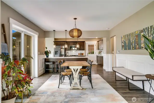 Dining is effortless when hosting friends! Situated between the living room and kitchen, the dining room serves as the ideal connection between the two spaces. A sliding glass door opens onto a view deck, perfect for enjoying your morning coffee while listening to the birds as they awaken in the trees.