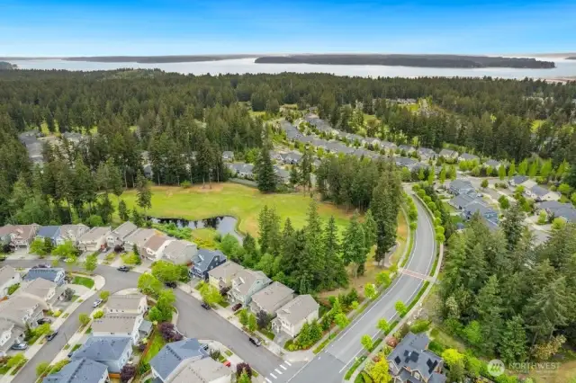 View of house on corner lot with golf course behind home. More privacy and great neighborhood.