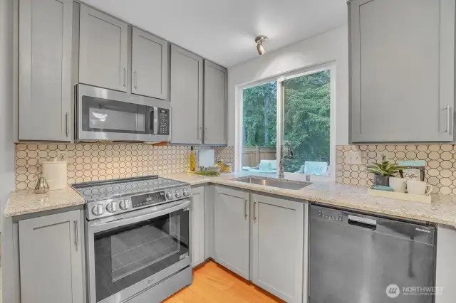 kitcheUpdated kitchen on the main floor includes upgraded appliances, painted cabinets, and stone countertops. n3