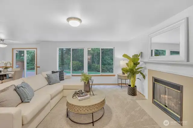 Large living space on the main floor with gas fireplace and views of the private back yard.