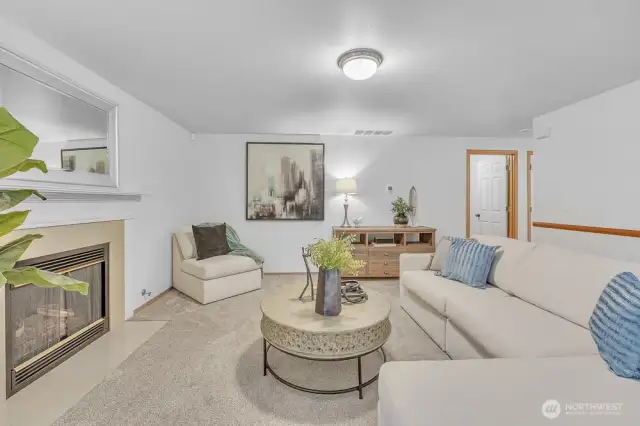 Large living space on the main floor with gas fireplace and views of the private back yard.
