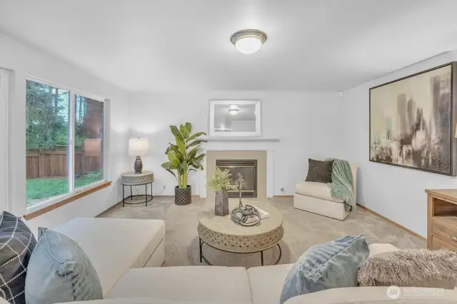 Large living space on the main floor with gas fireplace and views of the private back yard.