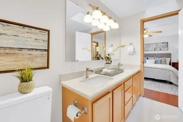 Primary en-suite features upgraded fixtures, stone slab countertops, and lots of natural light.