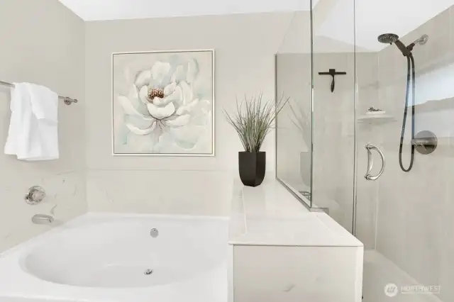 Primary en-suite features upgraded fixtures, stone slab countertops, and lots of natural light.