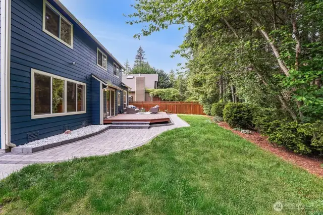 This home has so much privacy in the back yard. It features a large deck, new paver walkways with landscape lighting, and a large concrete patio on the side of the home.