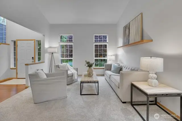 Large formal living room off the entrance with several windows.