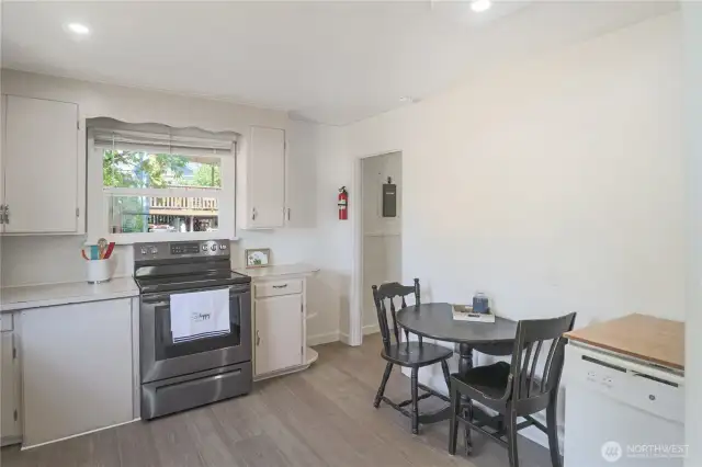 Inviting eat-in kitchen featuring timeless wood cabinetry and space for casual meals.