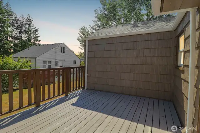 The back deck is ready for summer barbecues, gatherings, or quiet mornings.