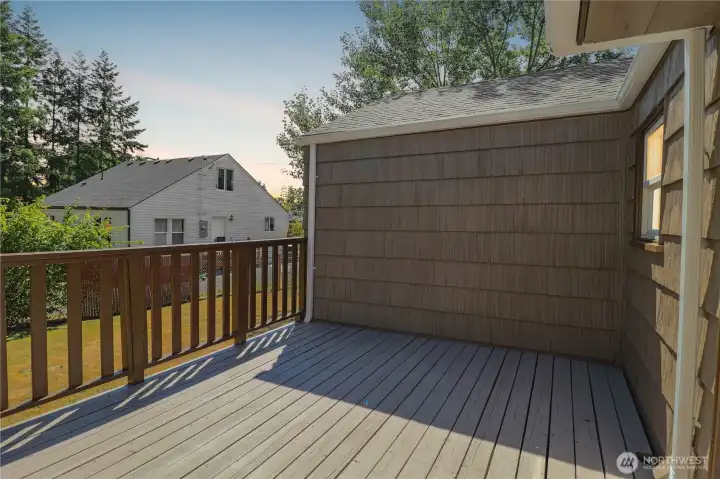 The back deck is ready for summer barbecues, gatherings, or quiet mornings.