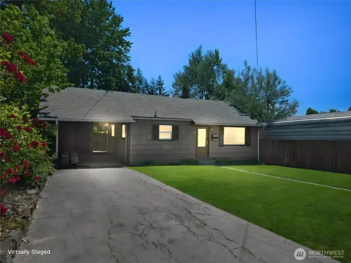 Virtual twilight view highlights the home's welcoming charm and curb appeal.