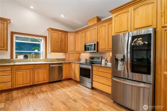 Slab granite counters, quality wood cabinets, and SS appliances. The refrigerator is unique: When you "tap" it the light inside comes on and you can see what's in the refrigerator. Pretty cool!
