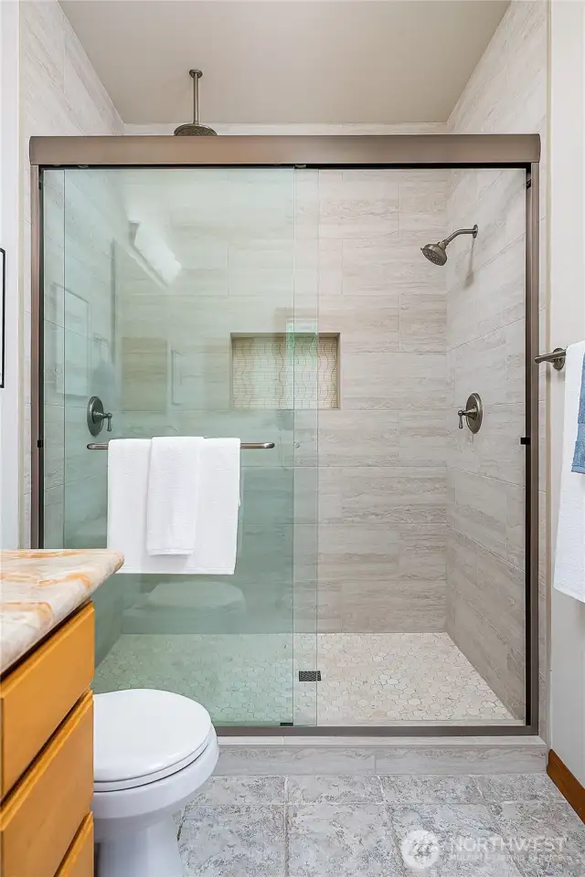 Newly remodeled extra-wide walk-in shower with custom tile work and two shower heads. You need to see it in person to appreciate.