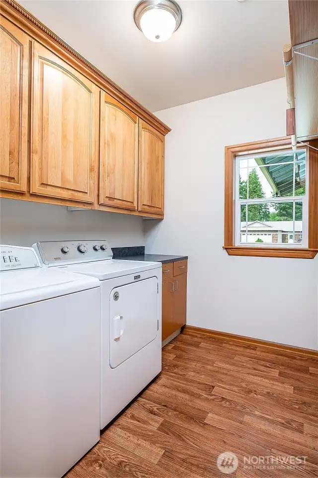 Utility room with washer/dryer and counter for folding clothes.
