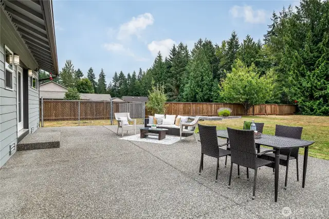 Oversized patio area provides ample space for entertaining. There is also a dog run on the back left. On the back right, there is access to the road. Perfect access for R/Vs, potential detached dwelling, and more.