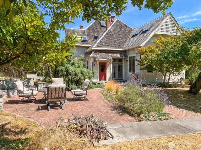 Pretty patio area for relaxing. Red door to the mudroom & half bath.  French doors to the kitchen.
