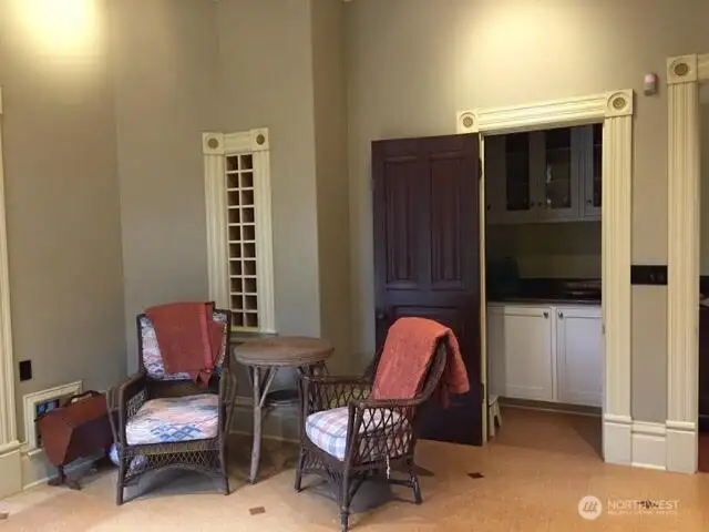 Small sitting area, built in wine rack and one of two pantries in the kitchen.