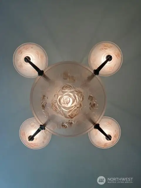 Living room is enhanced by this rose colored chandelier.