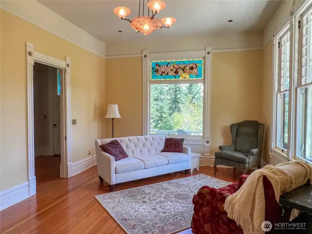 Stained glass embellishment in the living room with doorway to the hallway and front door.