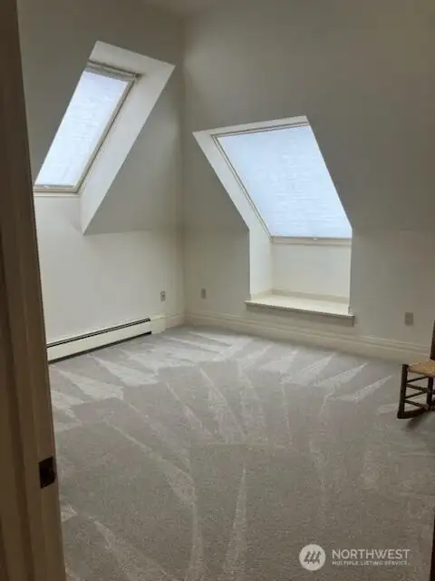 Room with 2 skylights at the top the staircase.