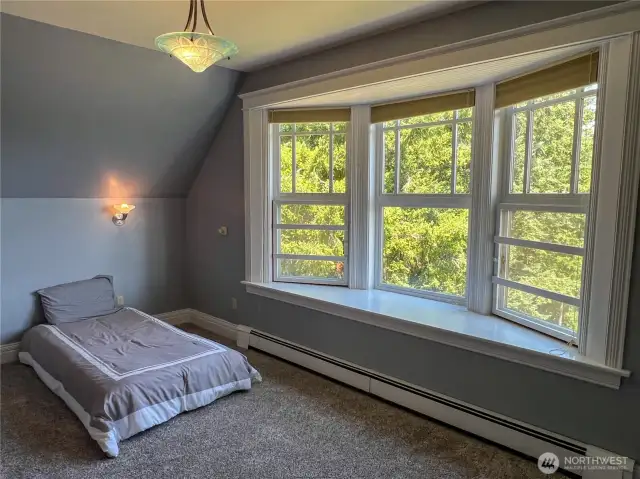 One of two other upstairs bedrooms with a bay window, built-in desk and walk-in closet.