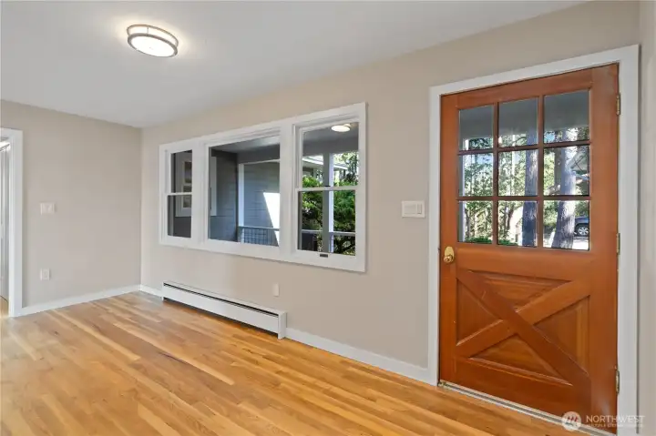 Front entryway has had a new front door installed since this photo. It features a glass panel on the upper portion. There is a large closet opposite the door.