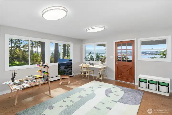 Versatile room off the kitchen—perfect as an artist’s studio, craft room, office, playroom, or sewing space—with a great view, deck access, and a new glass door available. It also doubles as the laundry room.