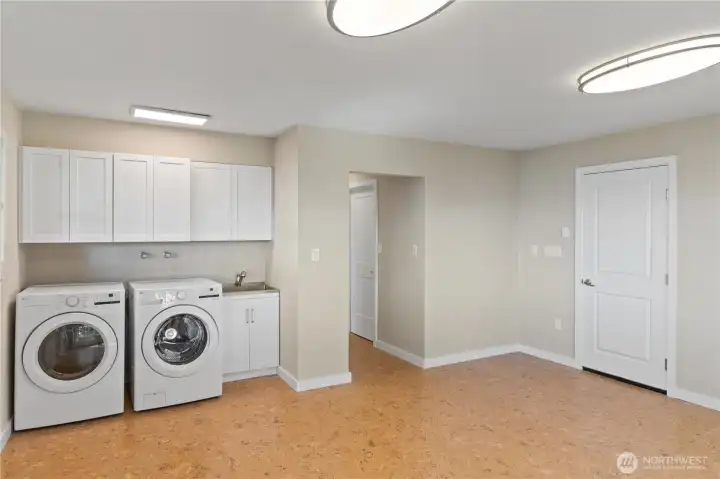 The door to the right comes in from the garage. This room contains the laundry but is flexible space.