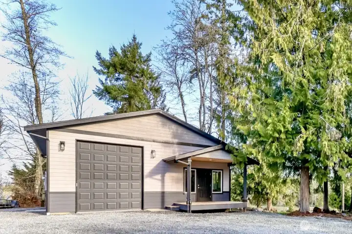 Front view of detached shop nestled in the trees.