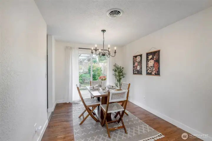 Designated dining space with access to patio and backyard through slider.