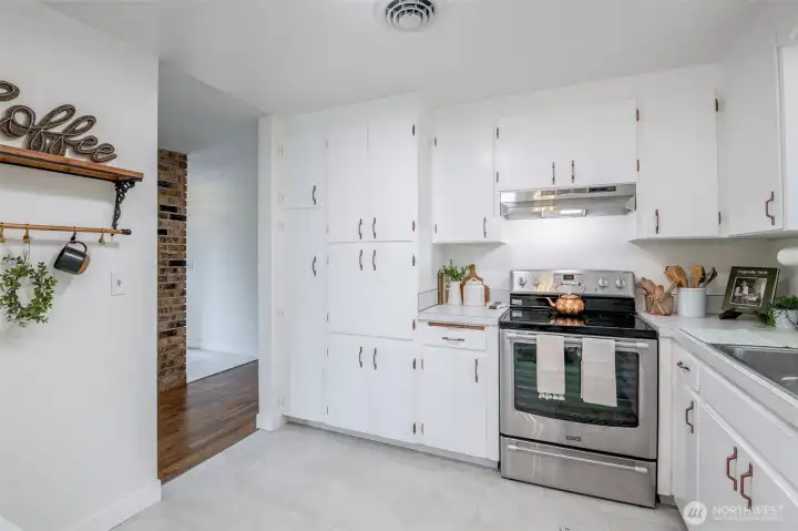 Refreshed yet charming kitchen with dainty details like copper hardware,