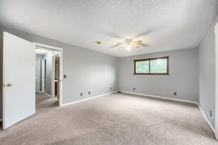Primary bedroom on the main with deck access. No staging. Primary bedroom on the main with deck access. No staging.