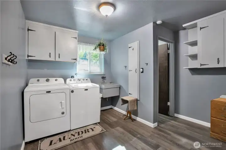Utility Room/Mud Room just off the garage with toilet and sink and storage