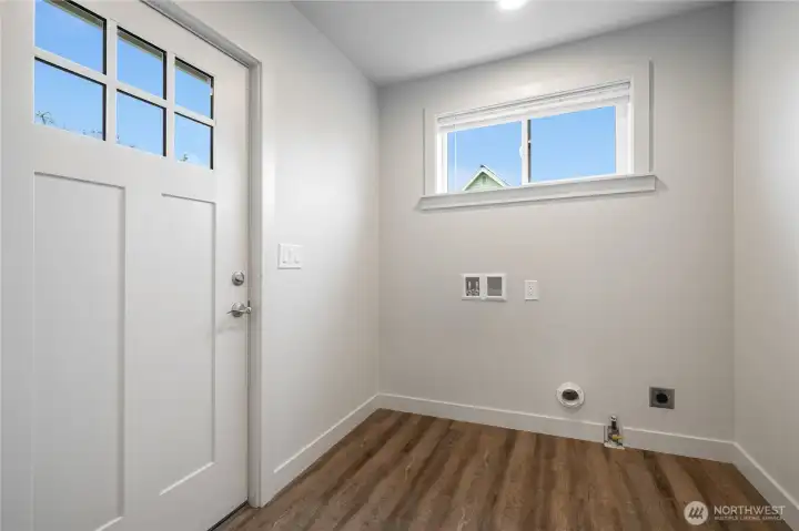 Laundry room off of kitchen with access to large back yard