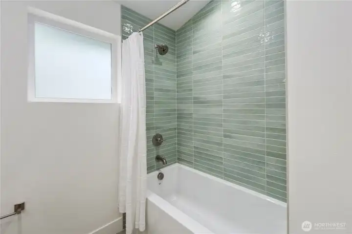 Guest bathroom with cool tiles and extra deep soaking tub