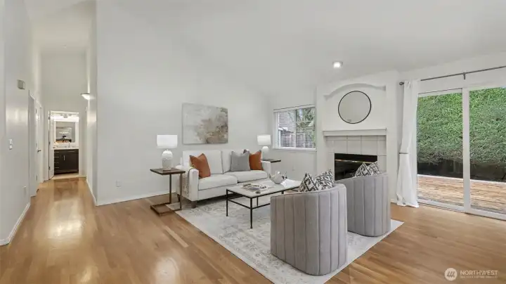 Living room with high vaulted ceilings. Looking down the hallway to BRs