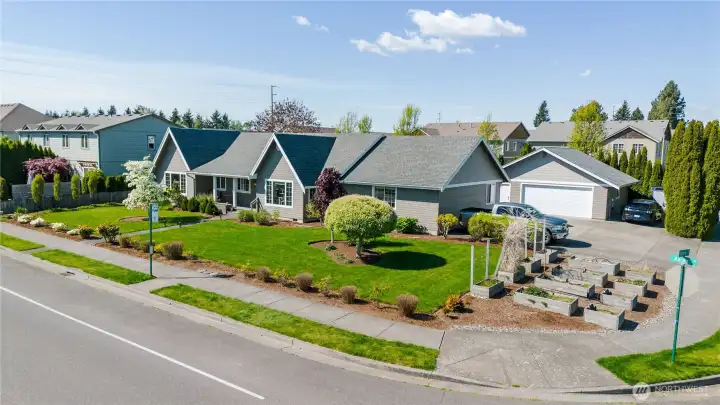 Large corner lot with beautifully landscaped front yard including 12 raised garden beds.