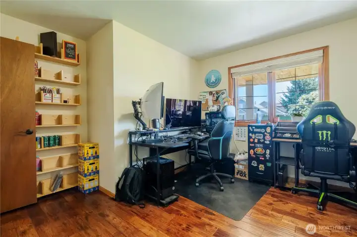 Den/ 4th bedroom faces front of house with hardwood floors.