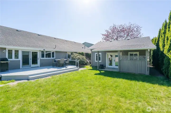 Private back yard looking towards detached cottage-style studio.