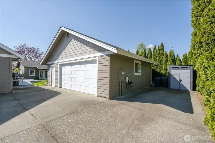 Oversized two-car garage with shop and storage space. RV parking next to garage.