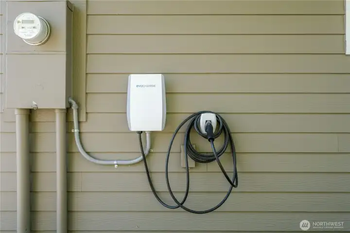 EV Car Charger on outside of garage. Second EV charger in garage.