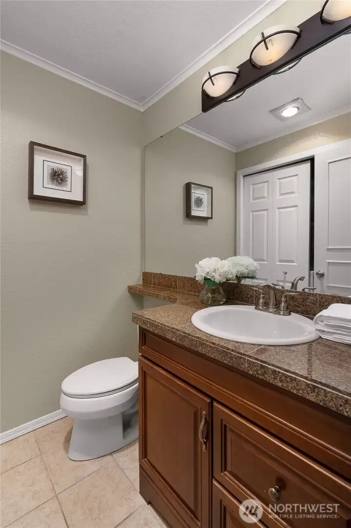 Main-level powder room for guests, with a conveniently located laundry closet on the opposite side (not shown in photos)