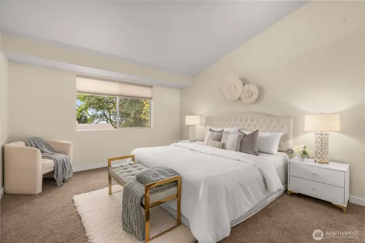 Primary bedroom with partial Lake Sammamish view and abundant natural light